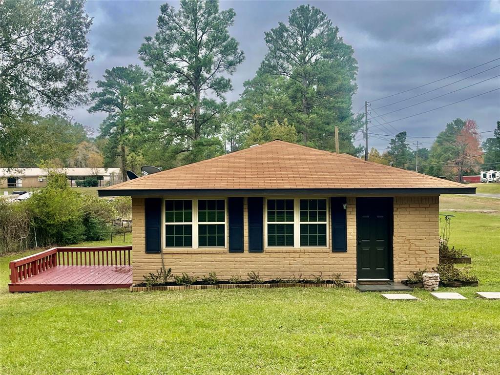 a view of a house with a yard and large window