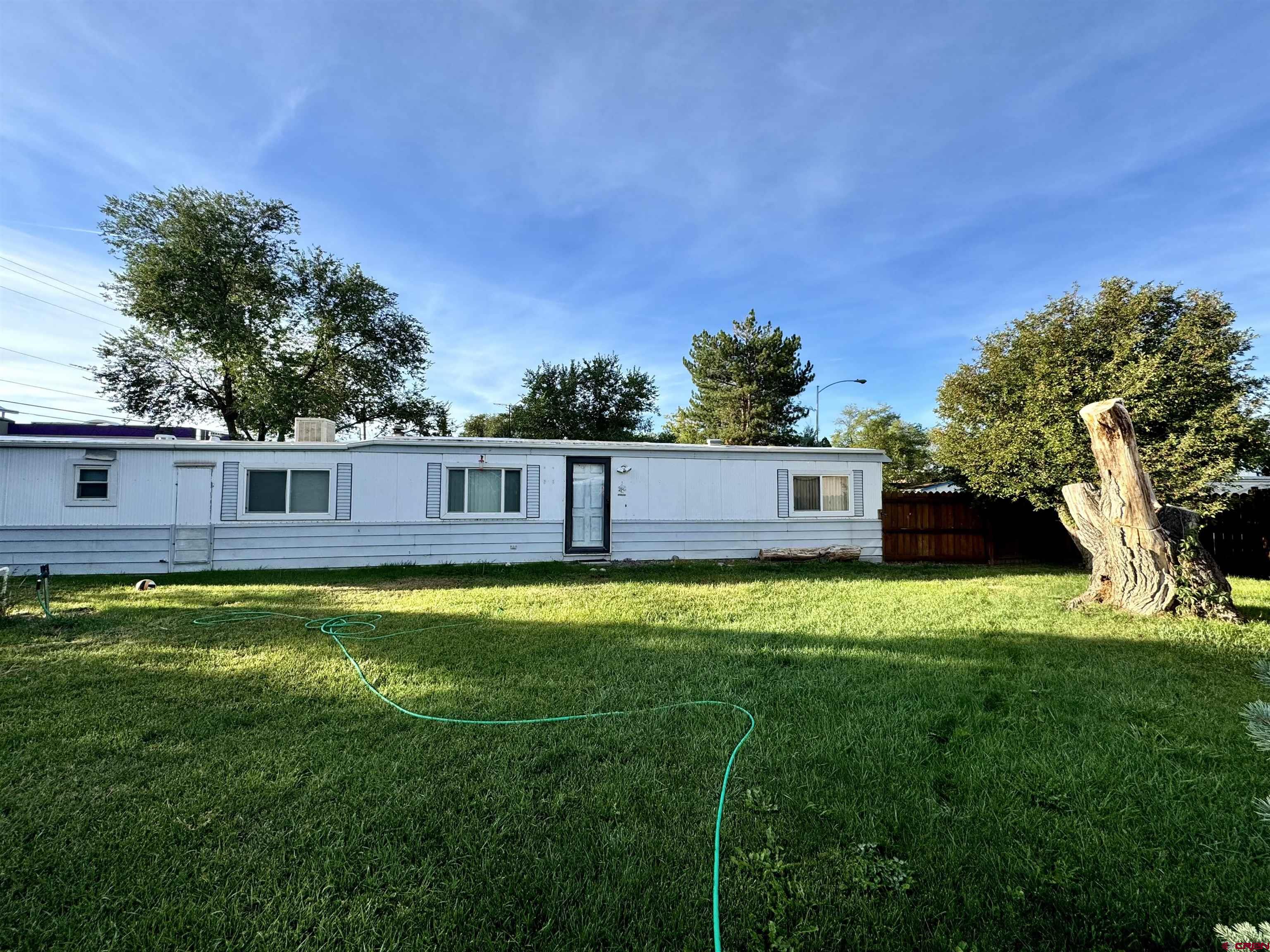 a view of a yard with a house in the background