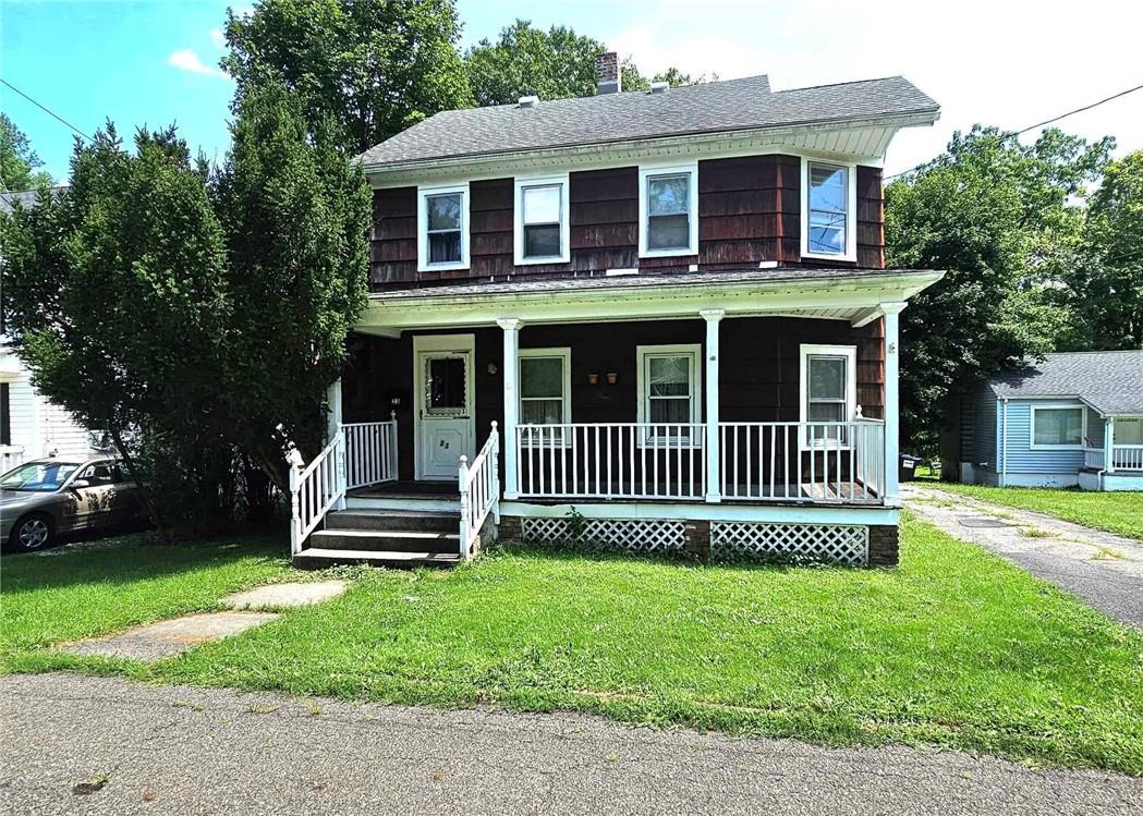 a front view of a house with a garden