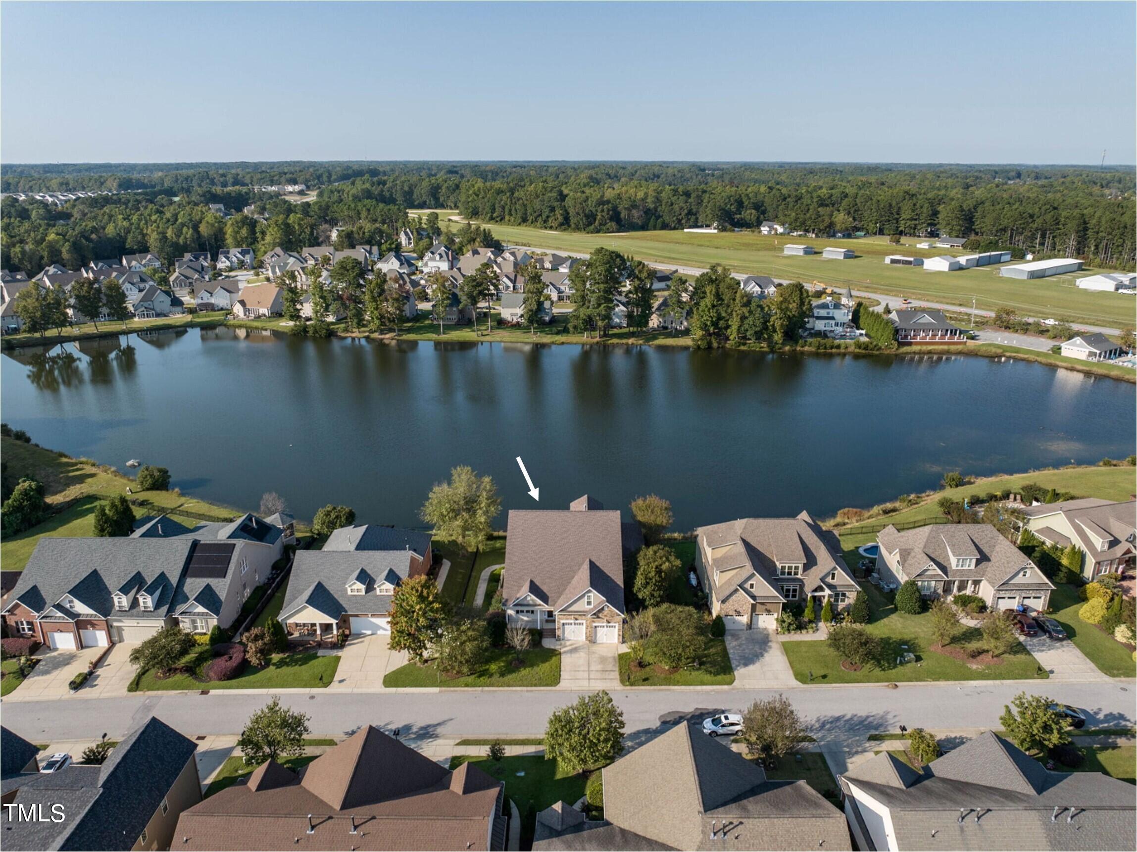 an aerial view of a house with a lake view