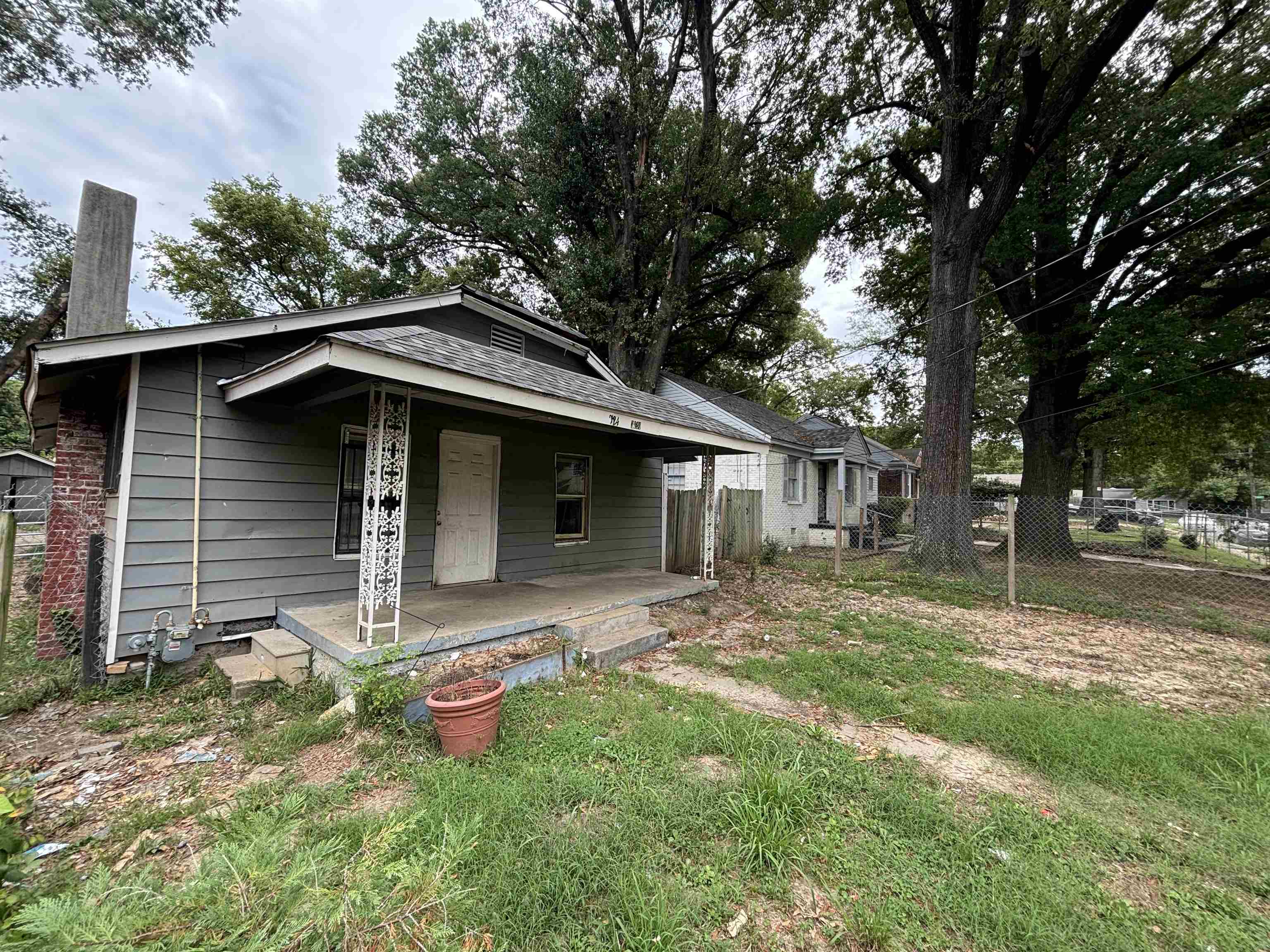 a front view of a house with yard and trees