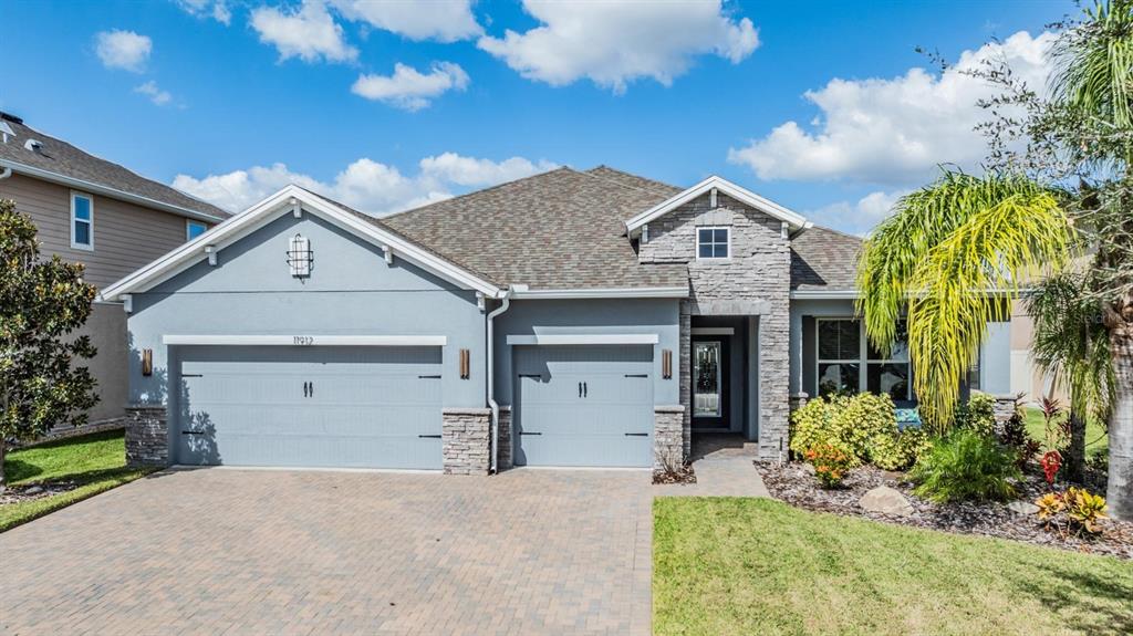 a front view of a house with a yard and garage