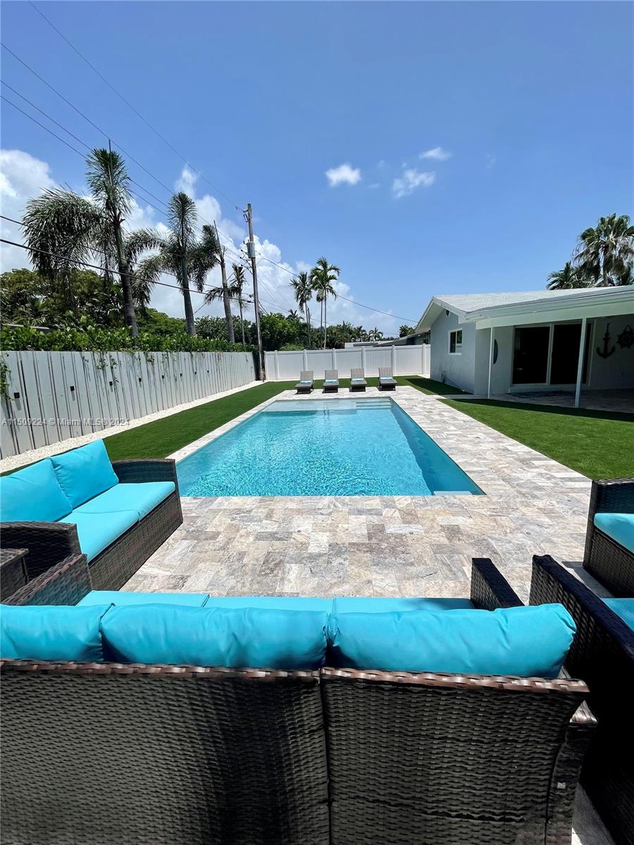 a view of a backyard with swimming pool