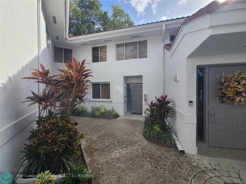 a front view of a house with garden