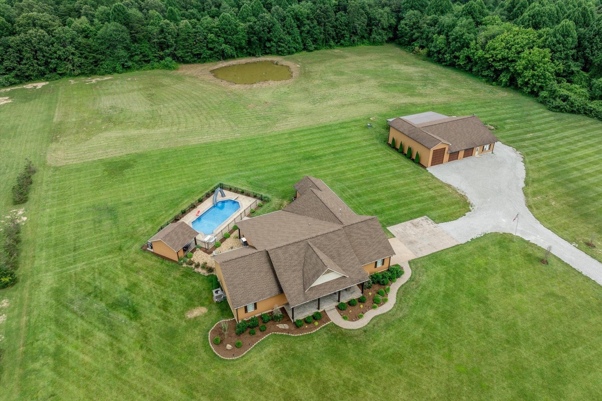 an aerial view of a house with a yard