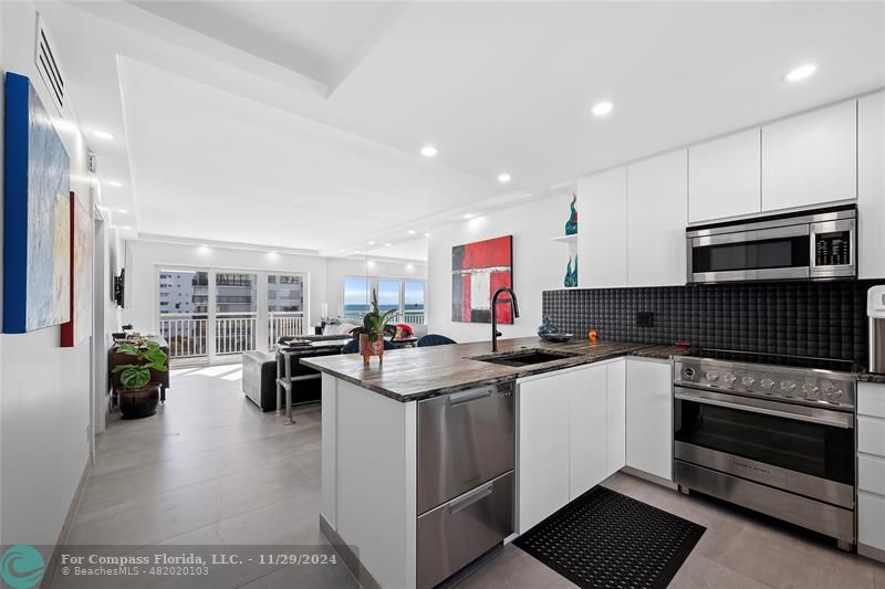 a kitchen with lots of counter space and wooden floor