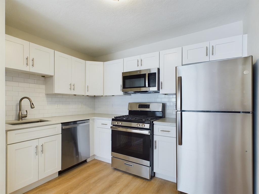 a white refrigerator freezer sitting in a kitchen