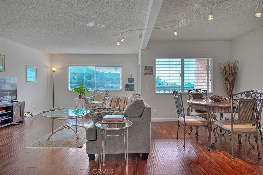 a living room with furniture dining table and a potted plant