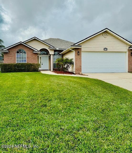 a front view of a house with a yard and garage