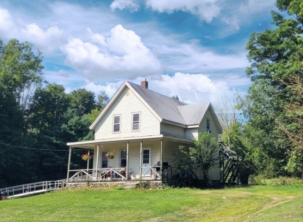 a view of a house with a yard patio and swimming pool