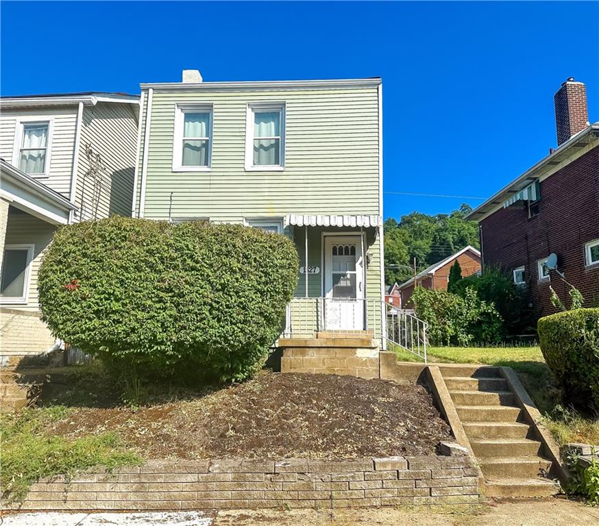 front view of a house with a yard