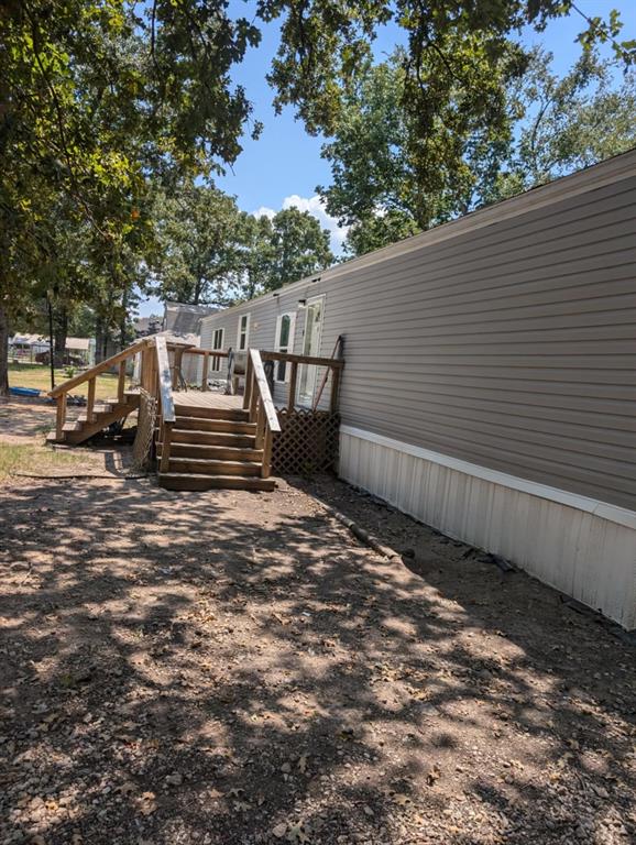 a view of a back yard with a wooden fence