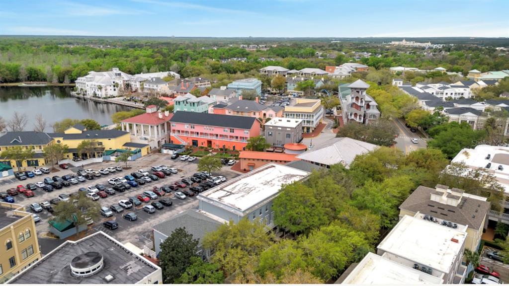 an aerial view of a city with lots of residential buildings lake and ocean view