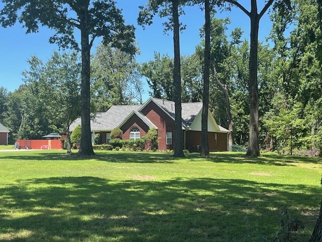 a view of a house with yard and tree s