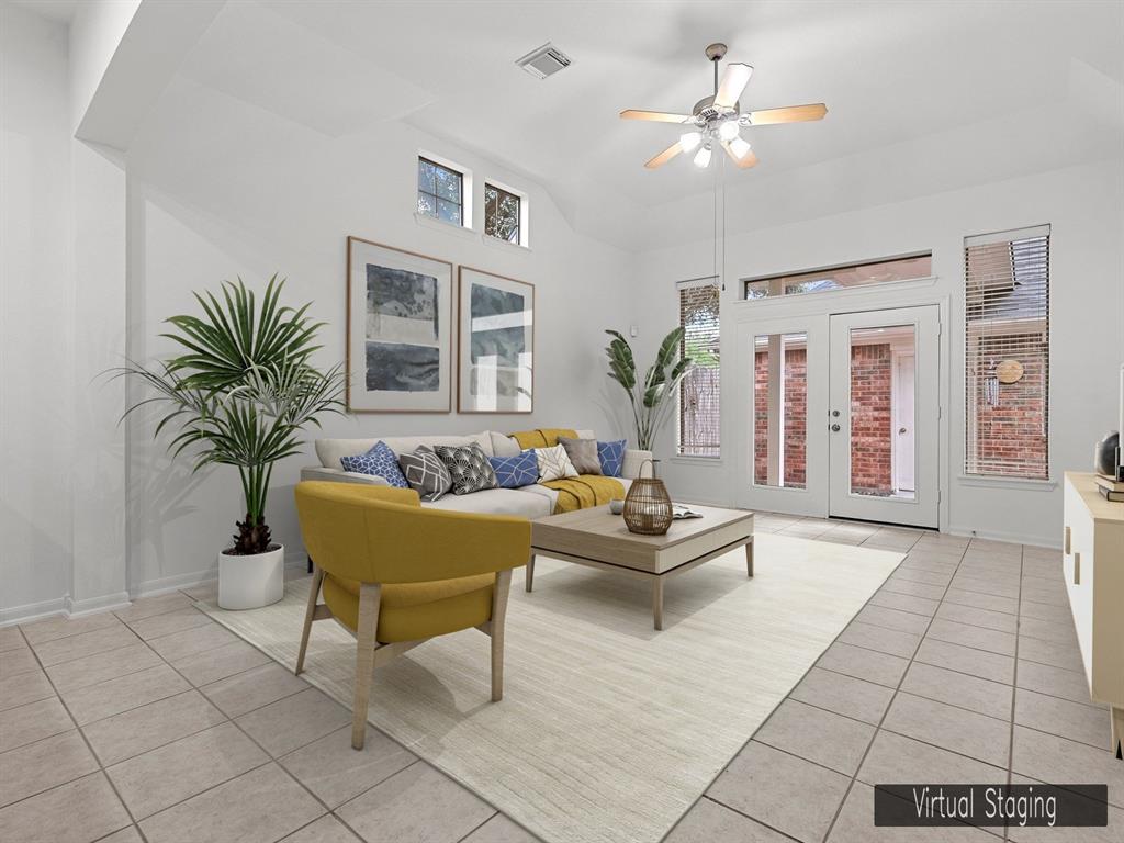 a living room with furniture and a potted plant