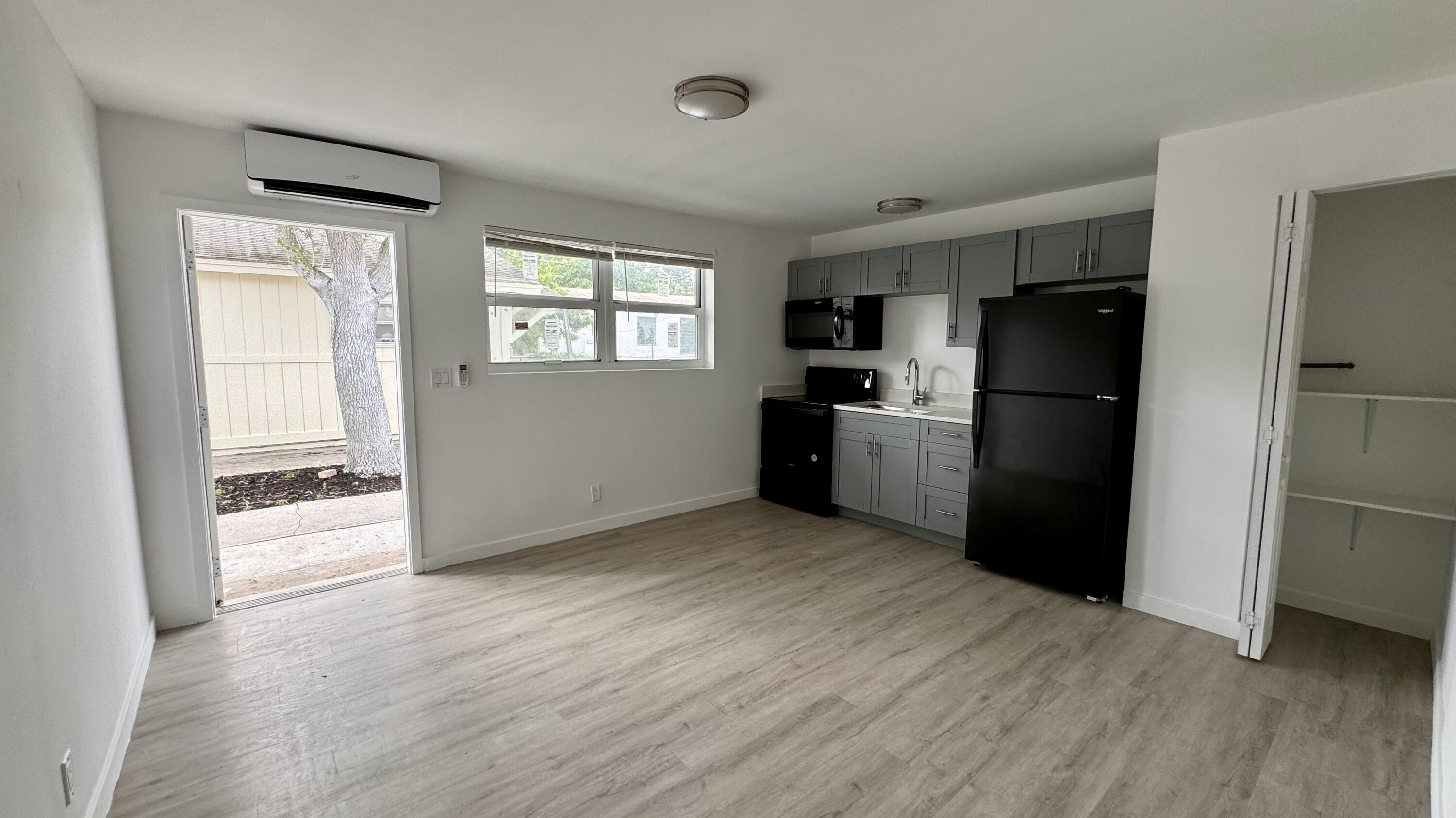 a kitchen with a refrigerator and a stove top oven