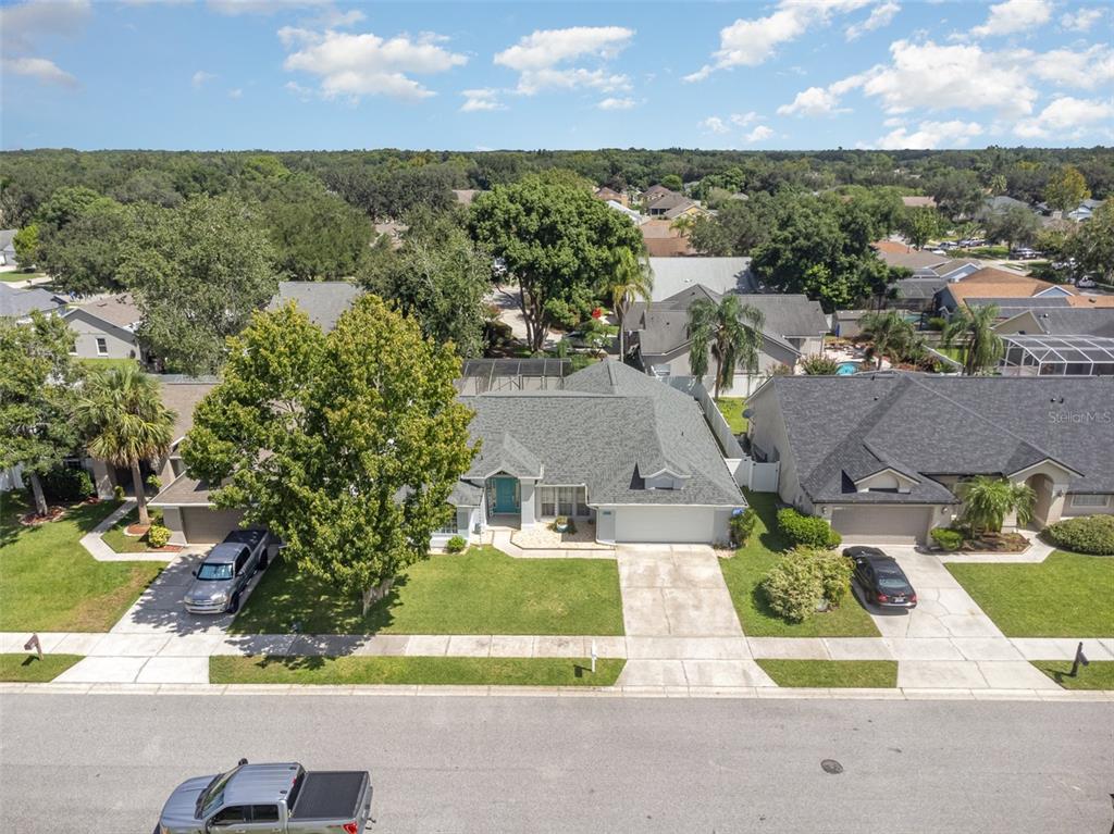 an aerial view of residential houses with yard