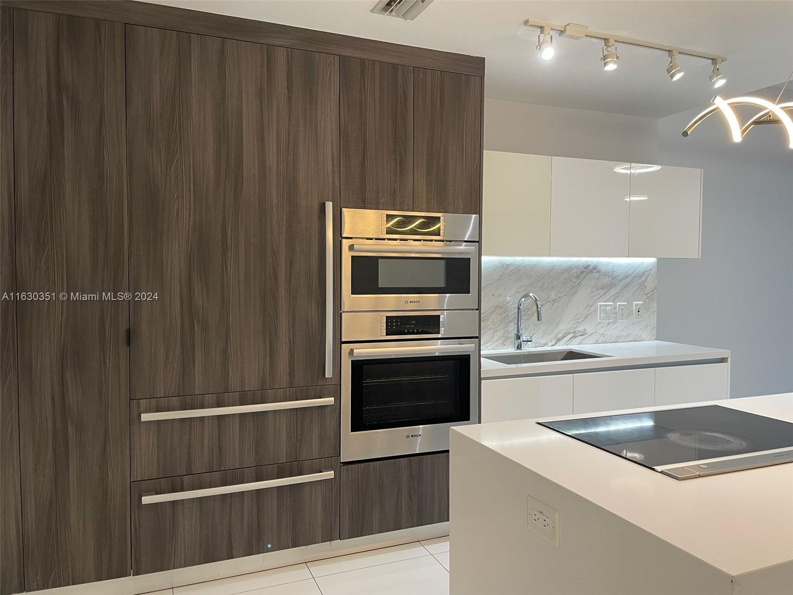 a kitchen with granite countertop a stove and a refrigerator