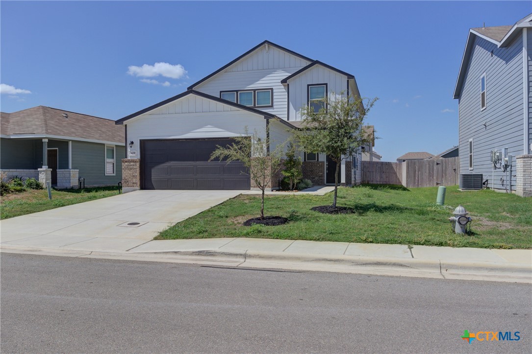 a front view of a house with a yard and garage