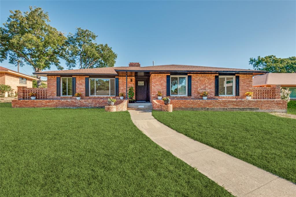 a view of a house with a yard and sitting area