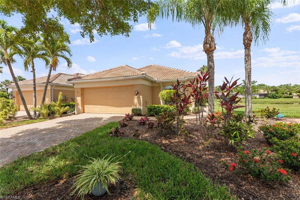 a front view of a house with a garden and yard