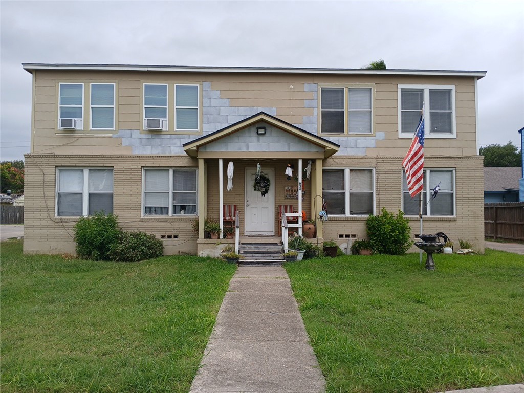 a front view of a house with a yard