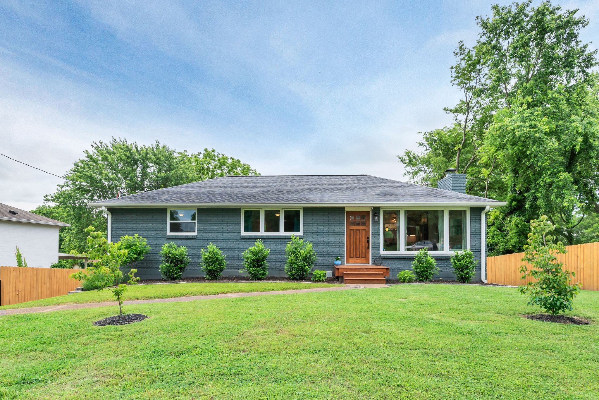 a front view of house with yard and green space