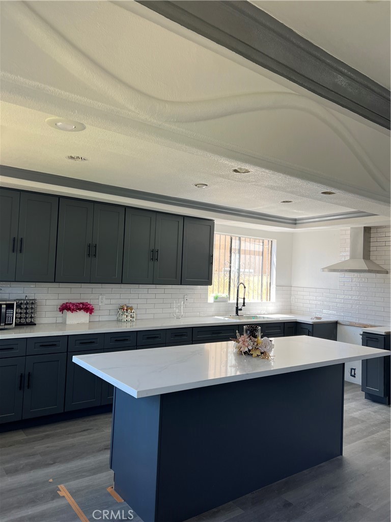 a kitchen with a sink a counter and cabinets