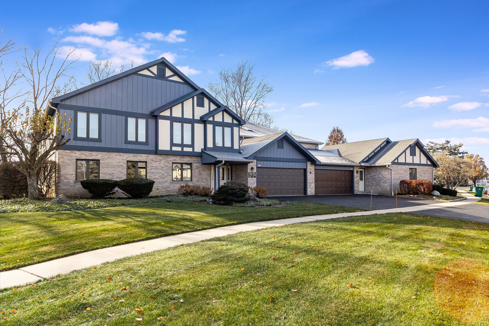 a view of a house with a big yard and large trees