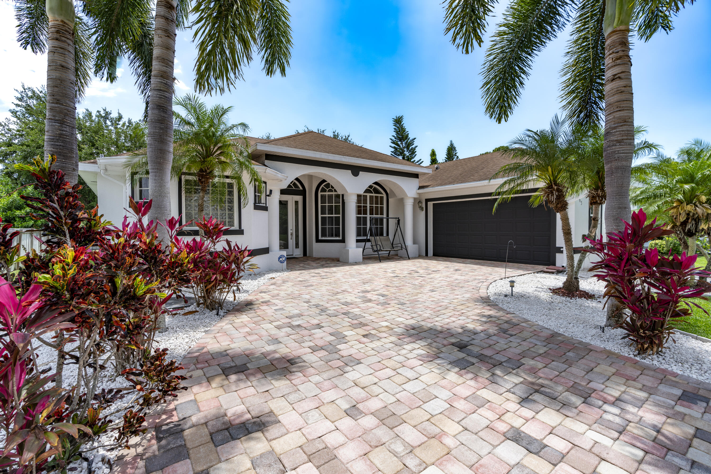 a front view of a house with a yard and a garage