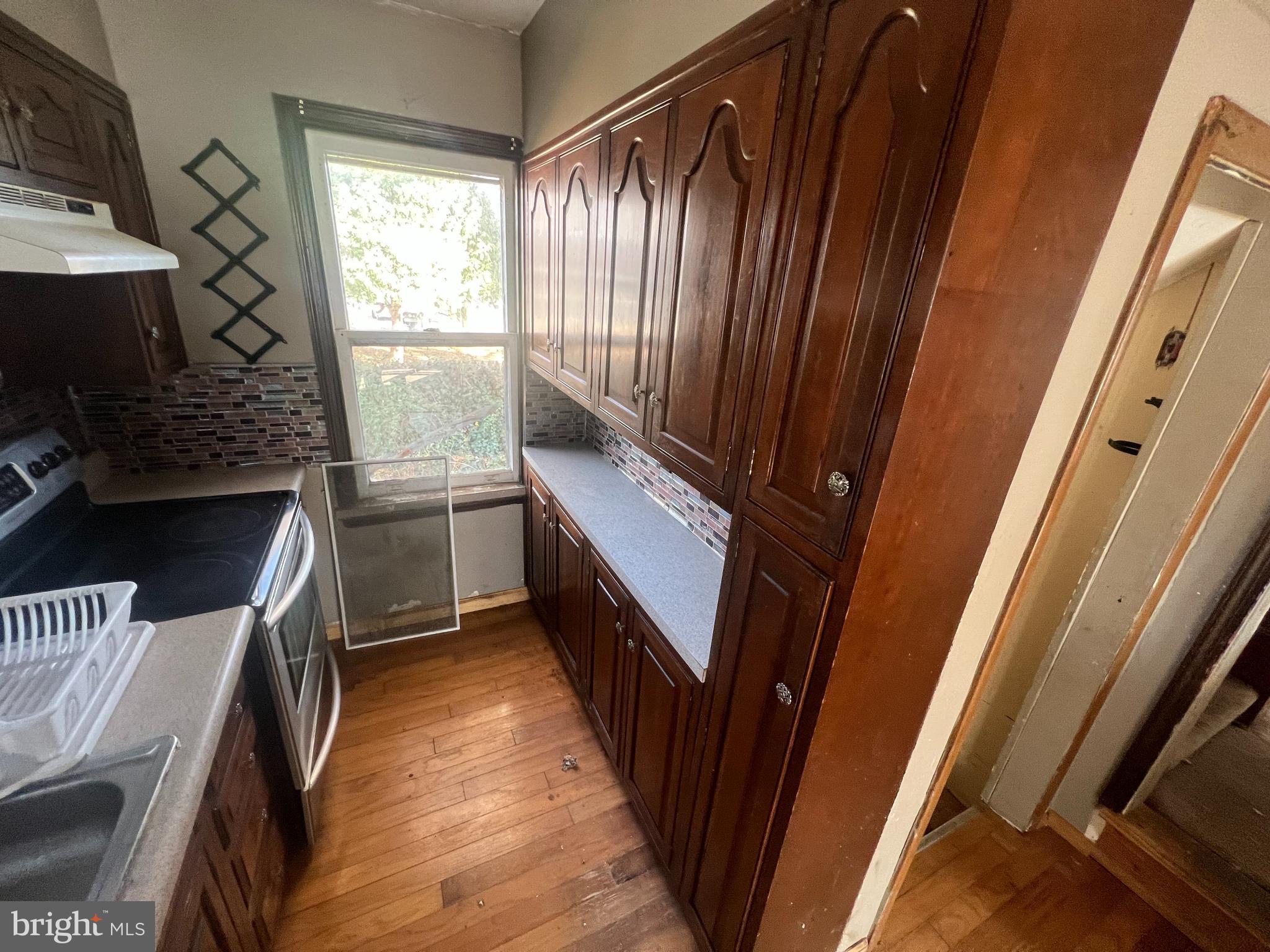 a kitchen with sink and refrigerator