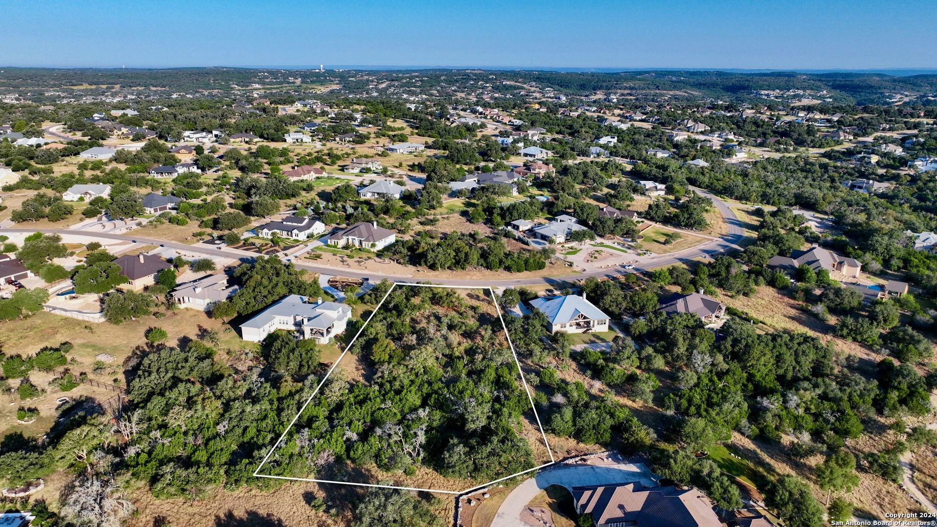 an aerial view of a houses with a yard