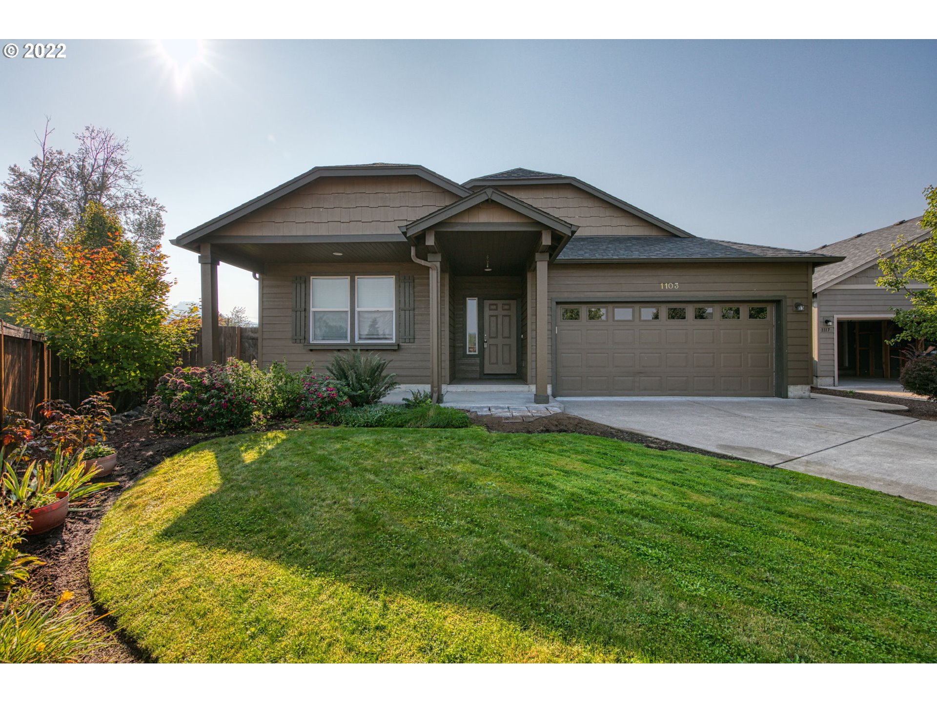 a front view of a house with a yard and garage