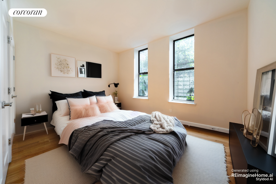 a bedroom with a bed a tv and next to a window