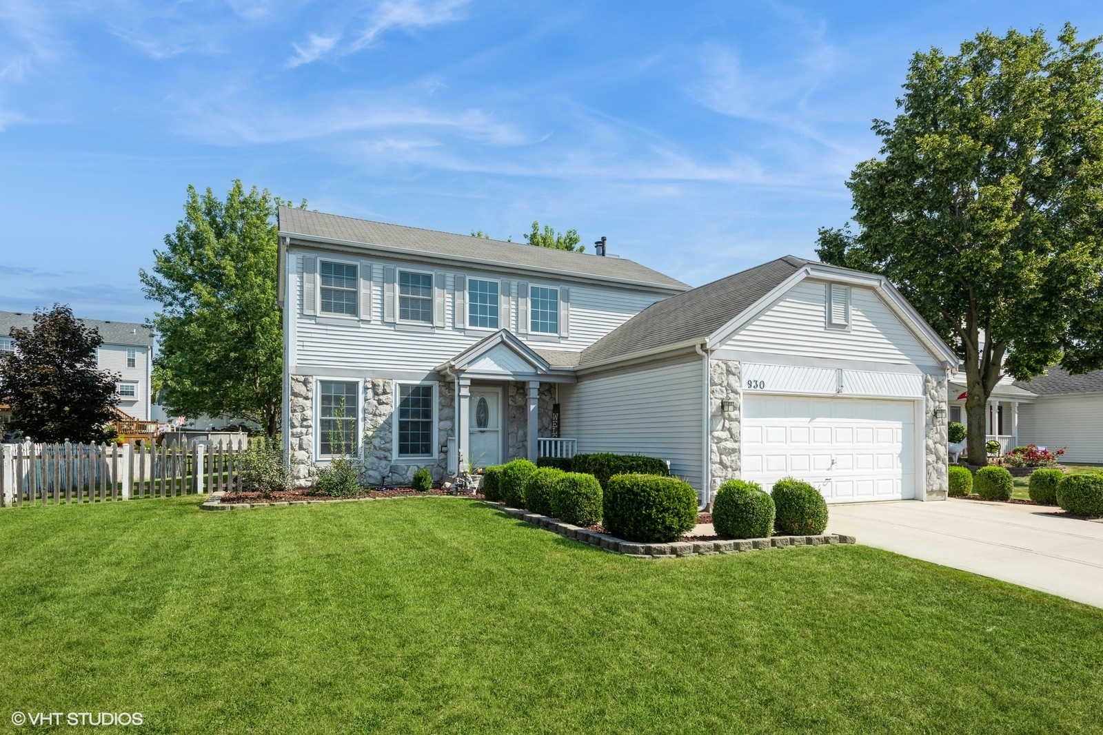 a front view of house with yard and green space