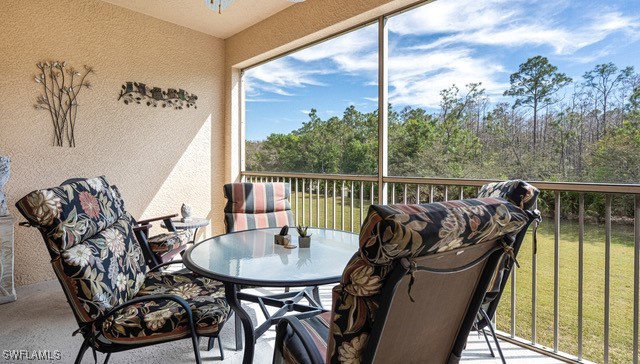 a balcony with table and chairs