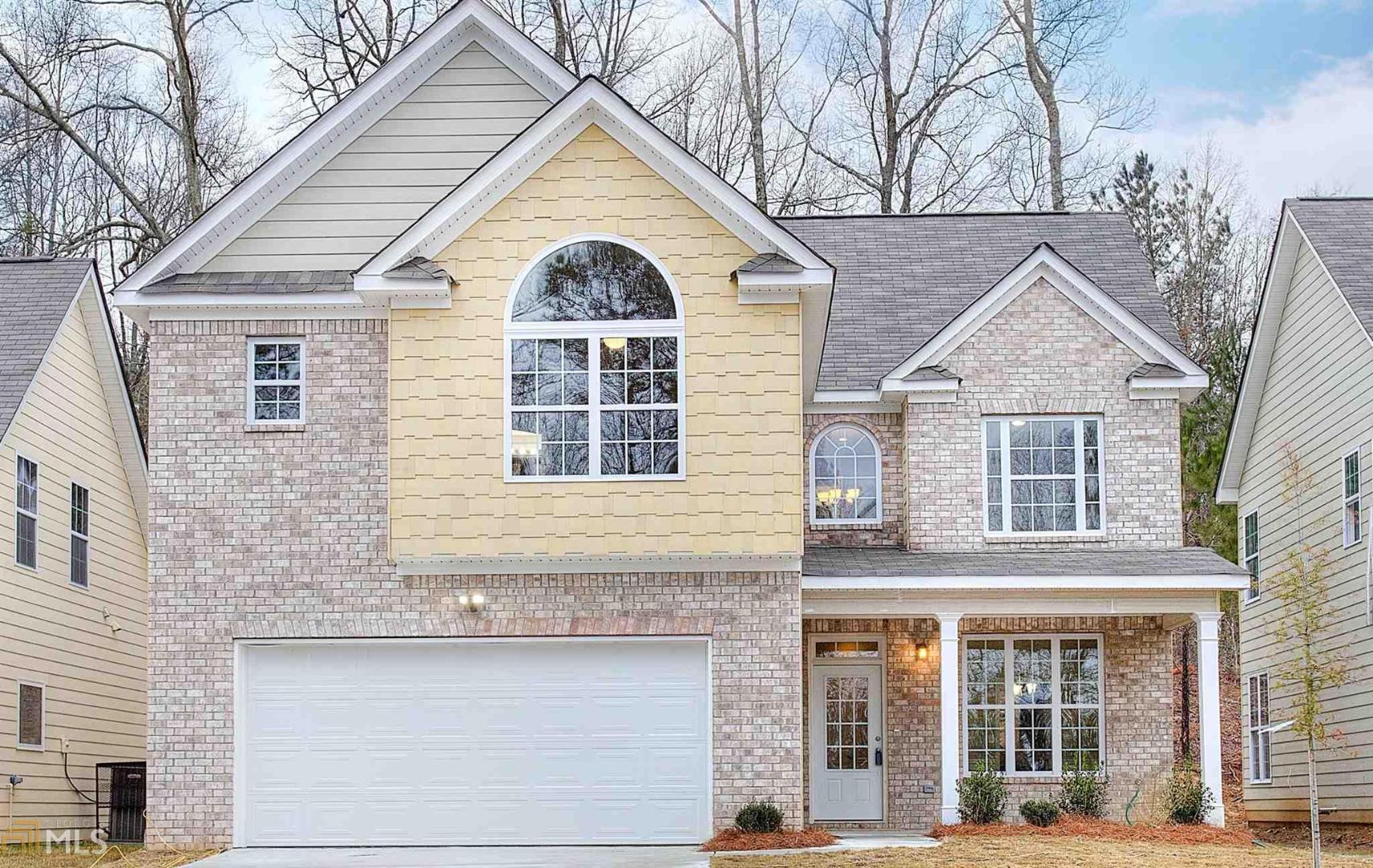 a view of a brick house with large windows