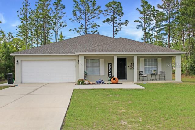 a front view of house with outdoor seating and yard