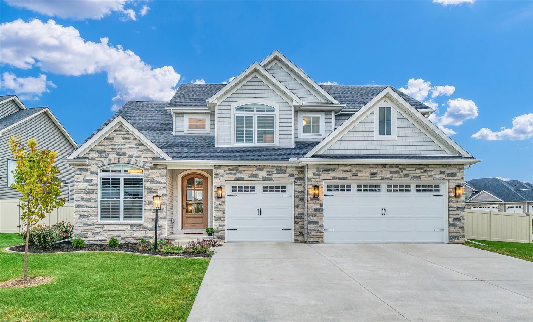 a front view of a house with a yard and garage