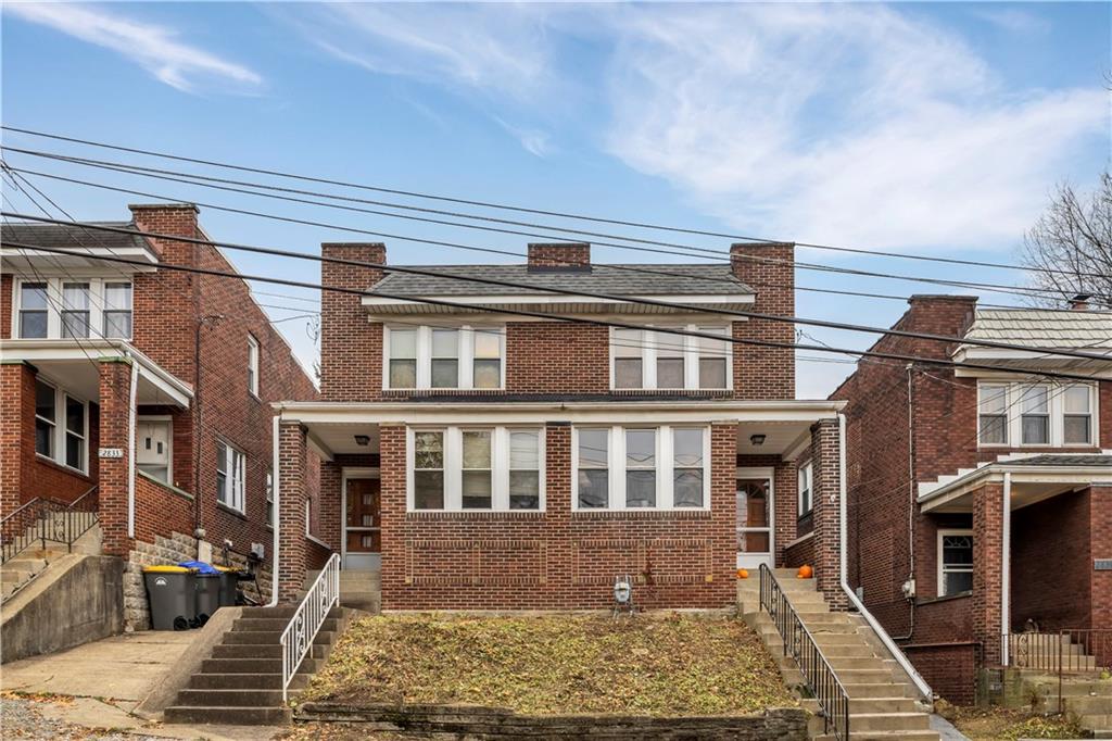 a front view of a residential apartment building with a yard