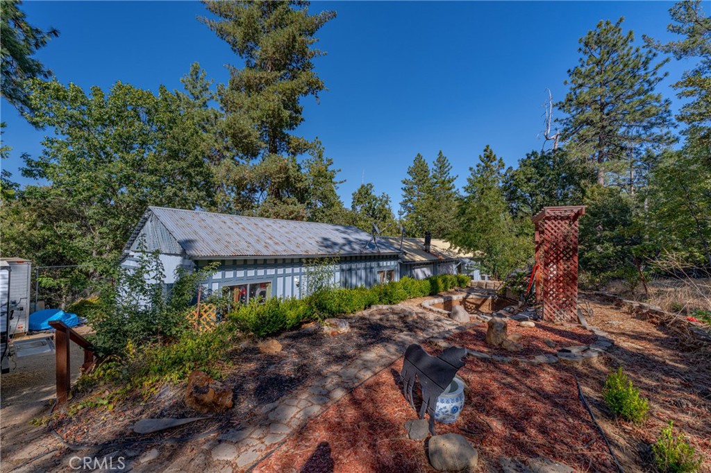 a view of house with outdoor space and garden