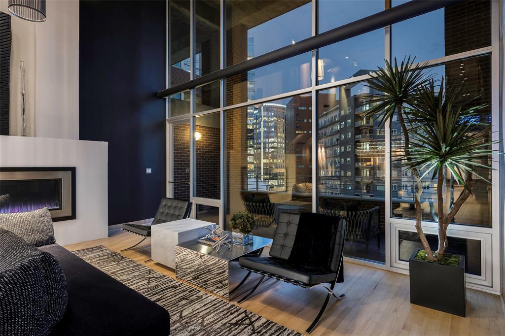 a living room with furniture rug and lamp