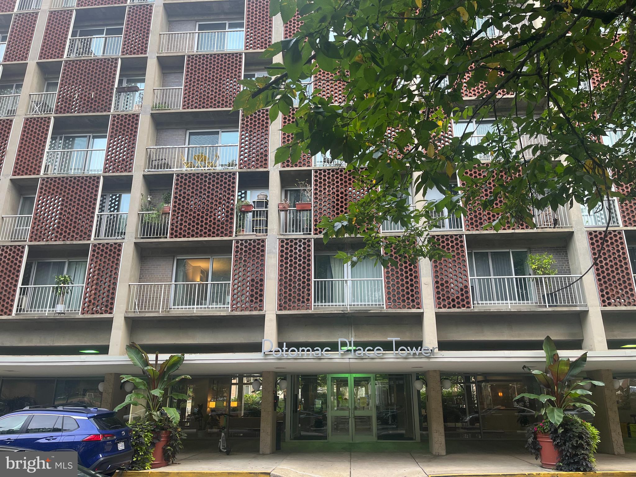 a front view of a building with a garden