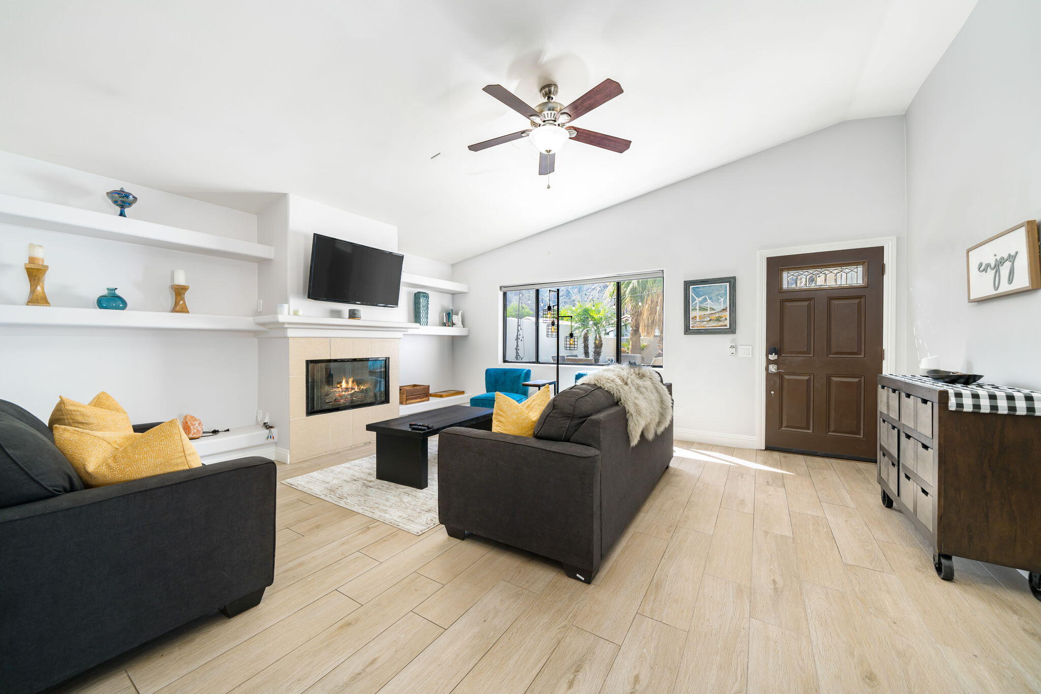 a living room with furniture fireplace and a window