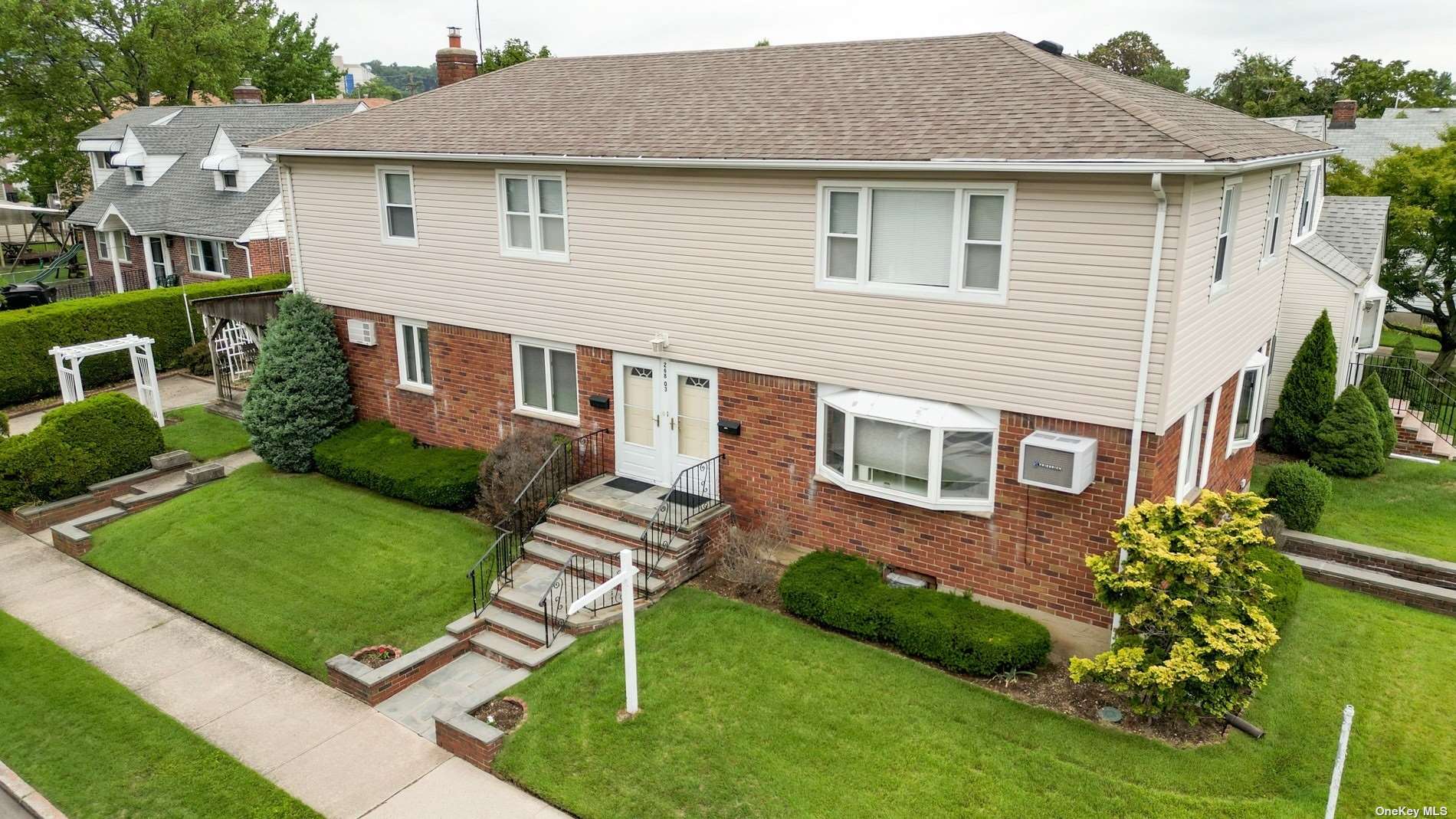 a aerial view of a house with a yard table and chairs