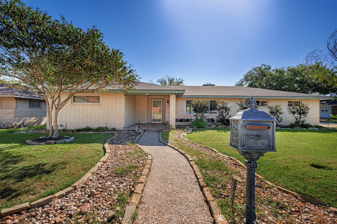 a front view of a house with garden