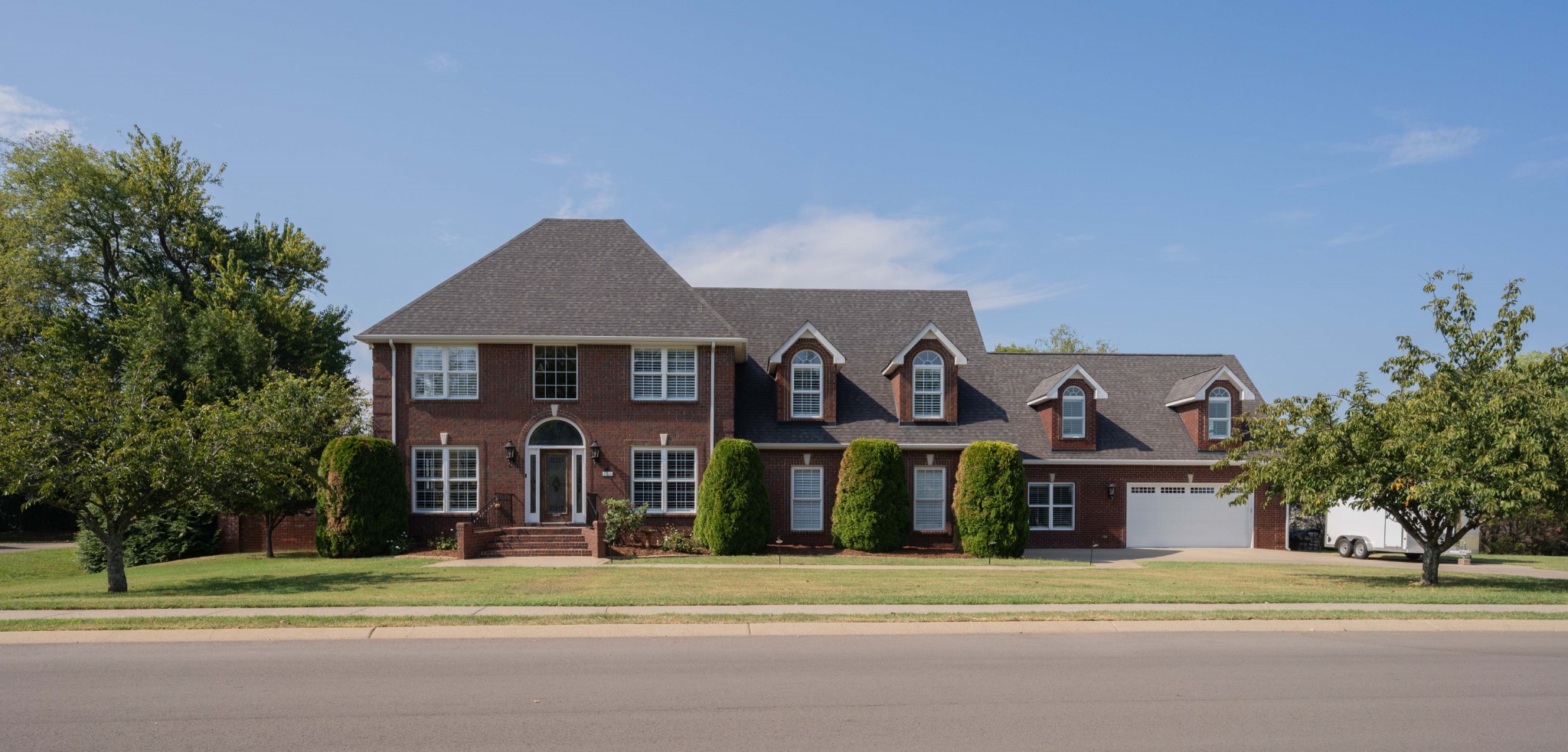 a front view of a house with a yard