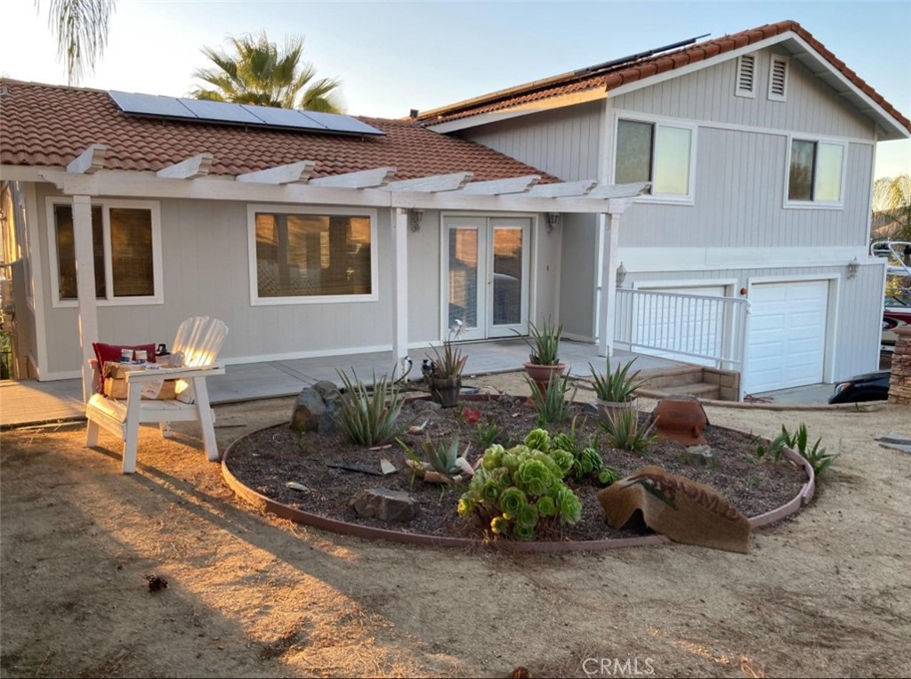 a front view of a house with sitting area