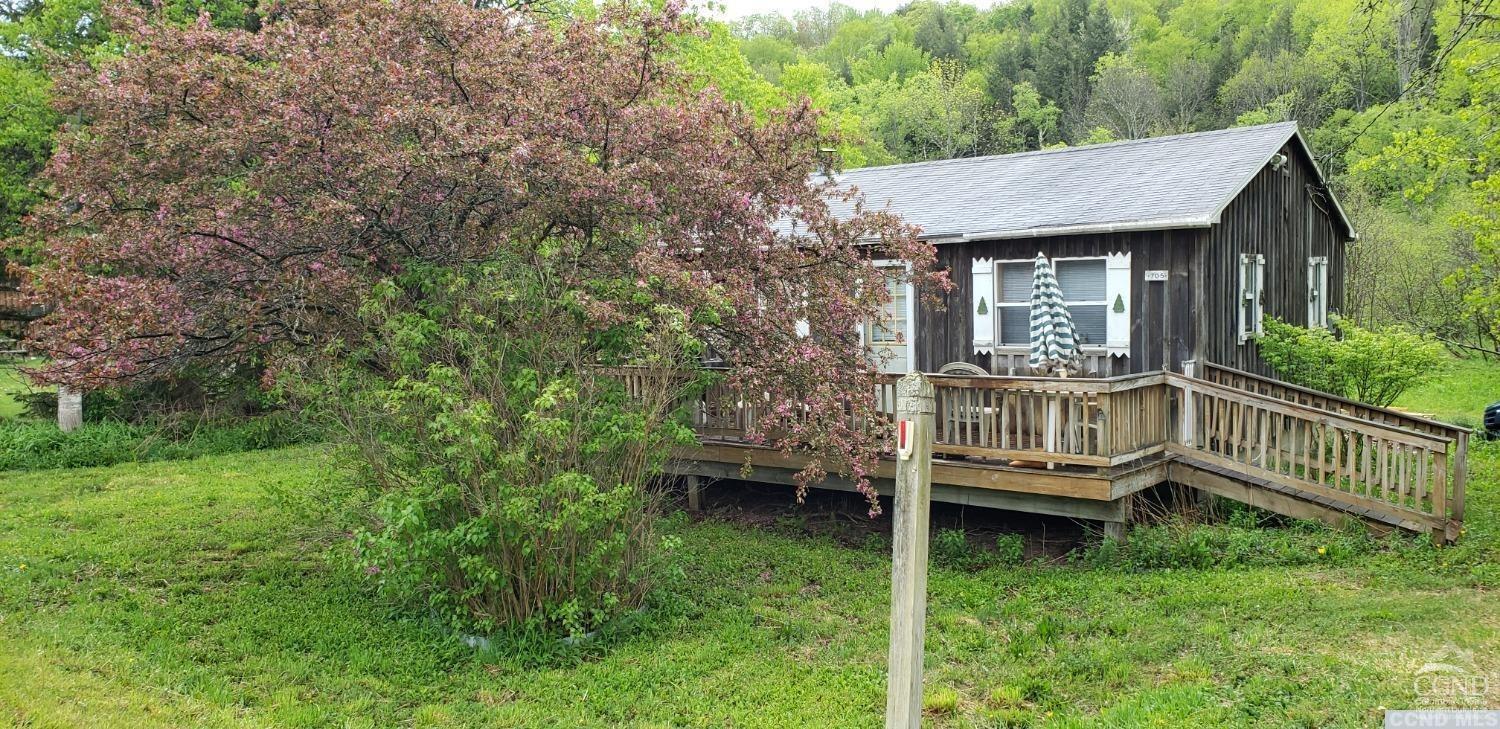 a view of a house with a balcony and wooden fence