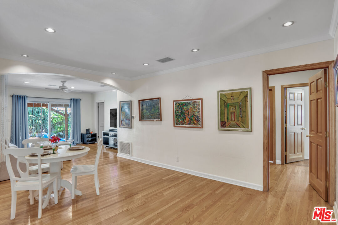 a living room with furniture dining table and a large window